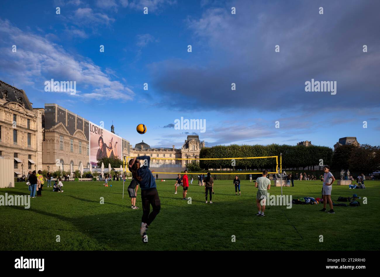 Young people playing volleyball, park, park area, Jardin du Carrousel, Musee des Arts decoratifs museum, Palais du Louvre, Paris, France Stock Photo