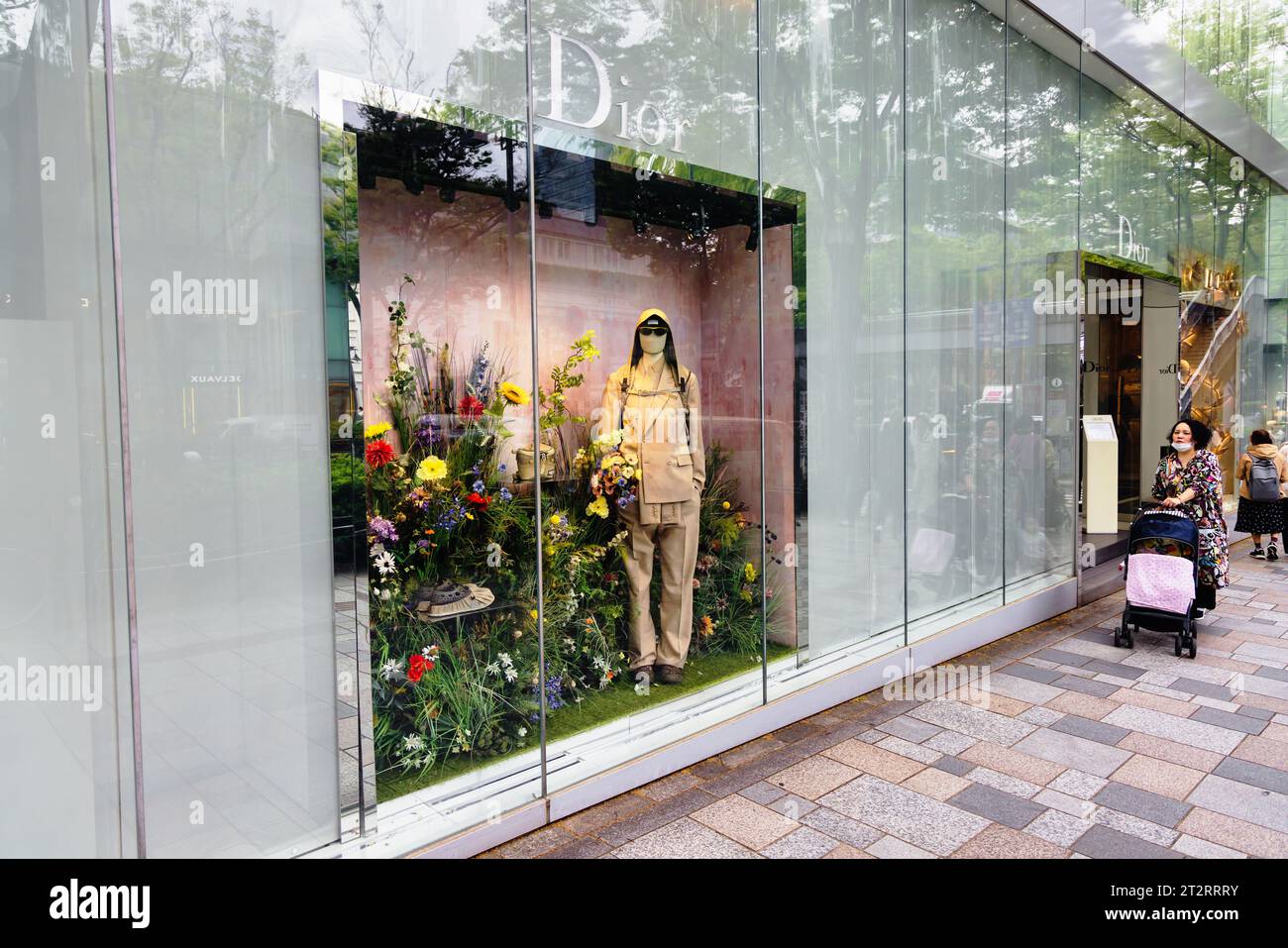 Tokyo, Japan - April 08, 2023: window display of a Dior store in Tokyo, with unidentified people. Dior is a French multinational luxury fashion house, Stock Photo