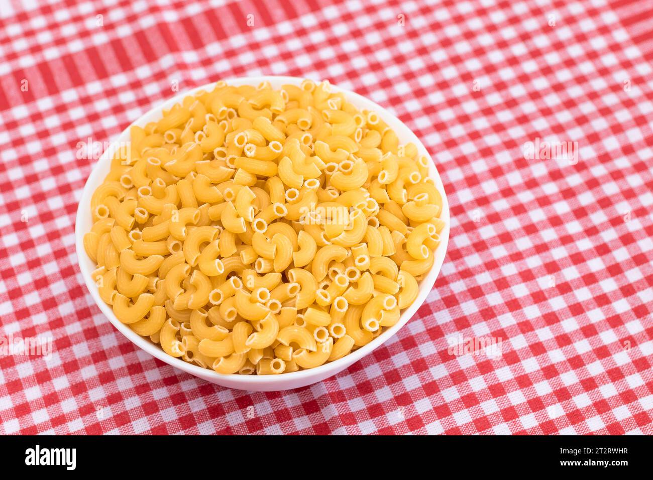 Uncooked Chifferi Rigati Pasta in White Cup on Red Checkered Towel. Fat ...