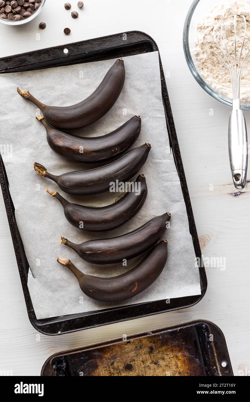 Roasted bananas on a parchment paper lined baking sheet for making