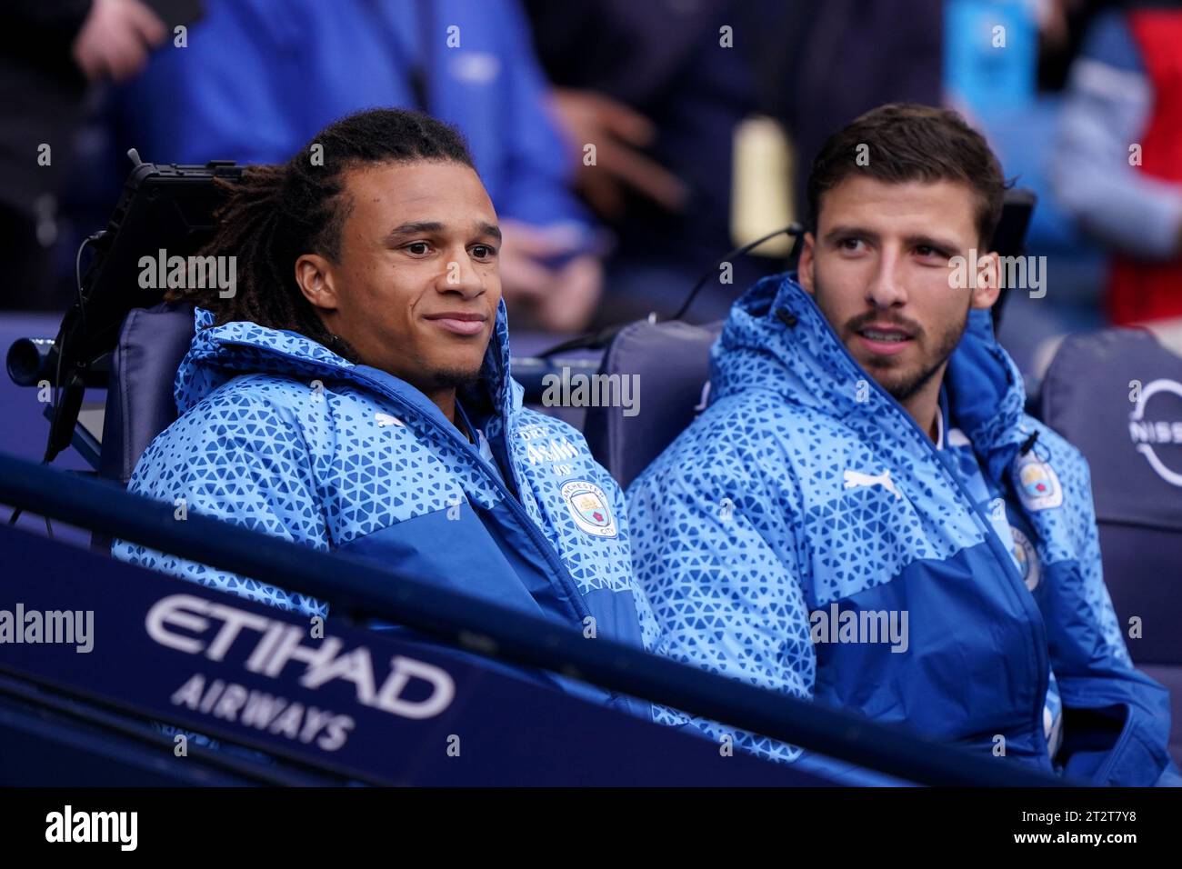 Manchester City substitutes Nathan Ake (left) and Ruben Dias before the Premier League match at the Etihad Stadium, Manchester. Picture date: Saturday October 21, 2023. Stock Photo