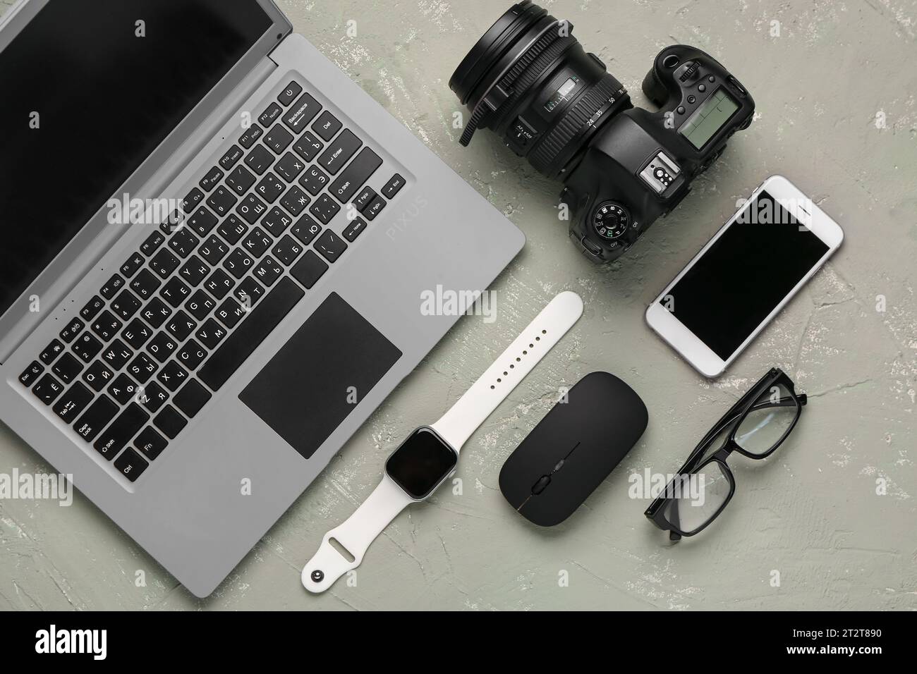 Modern gadgets with eyeglasses on grunge background Stock Photo
