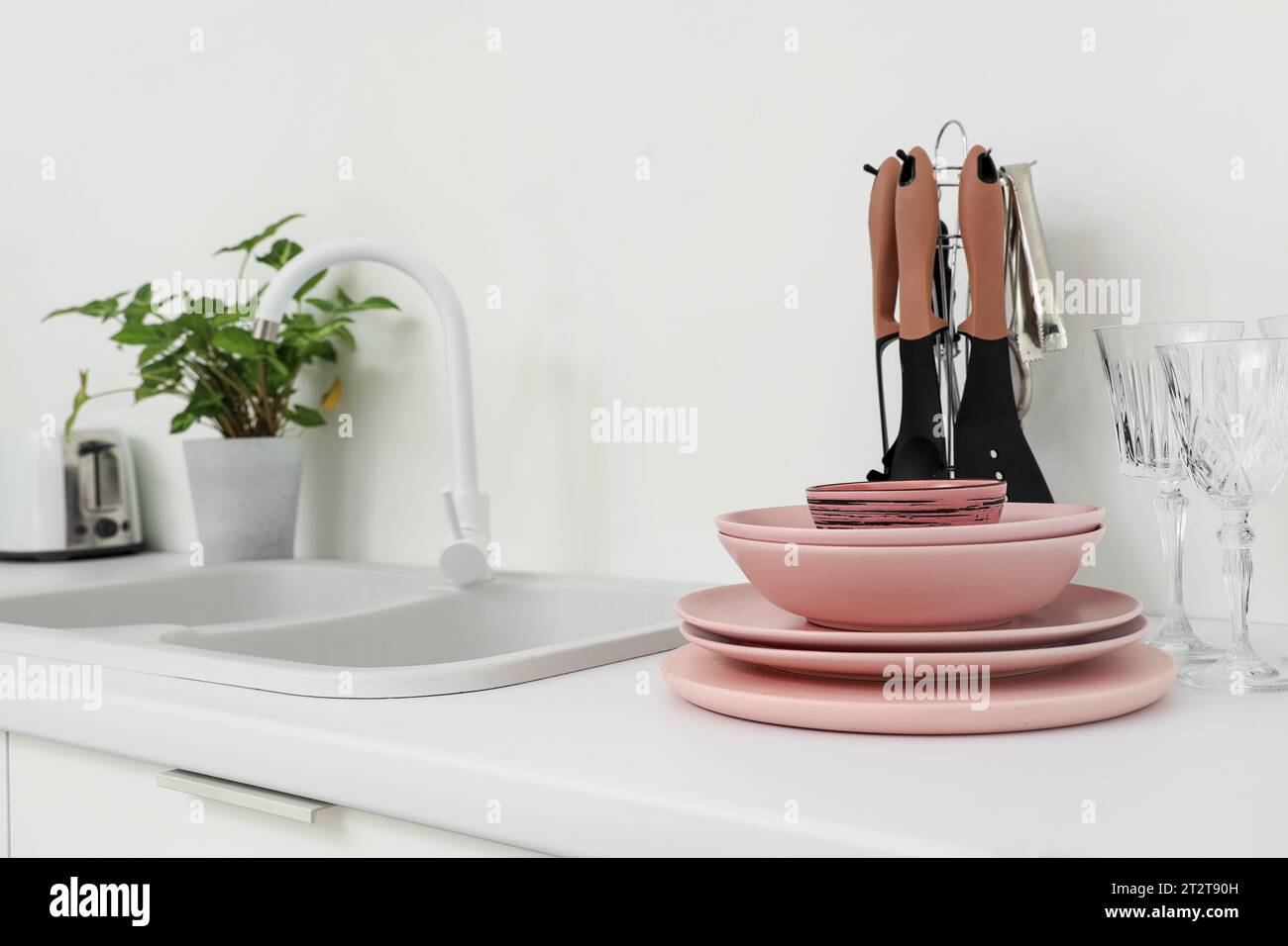 Set of clean pink dishes on counter in kitchen, closeup Stock Photo - Alamy