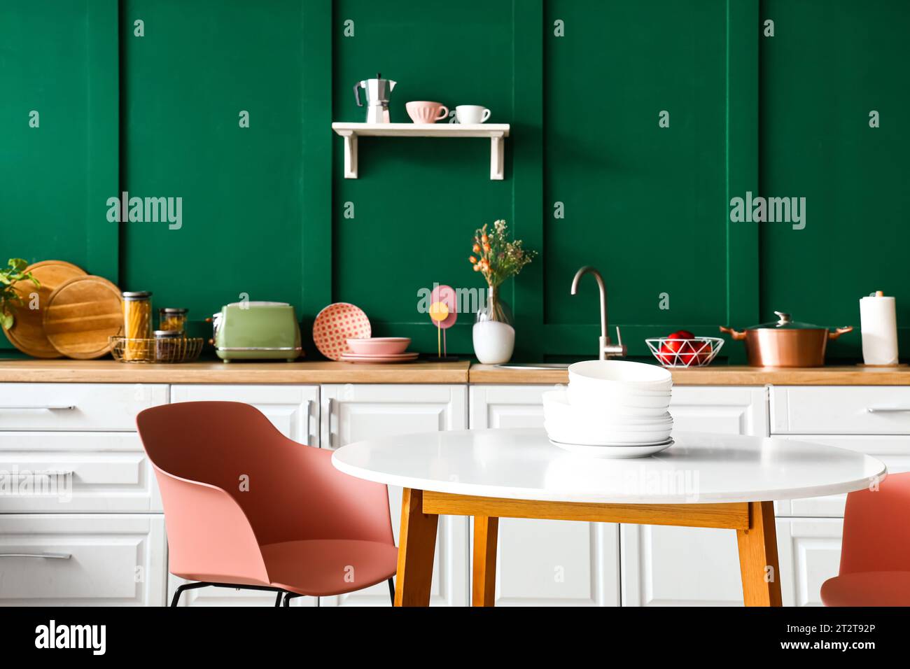 Interior of modern kitchen with white counters and dining table Stock ...