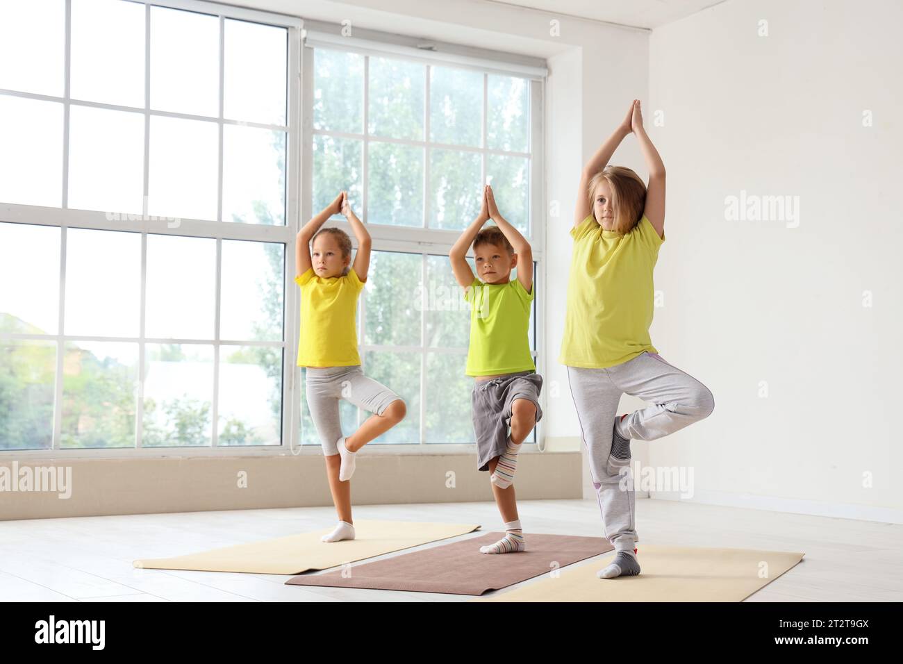 Group of little children practicing yoga in gym Stock Photo - Alamy