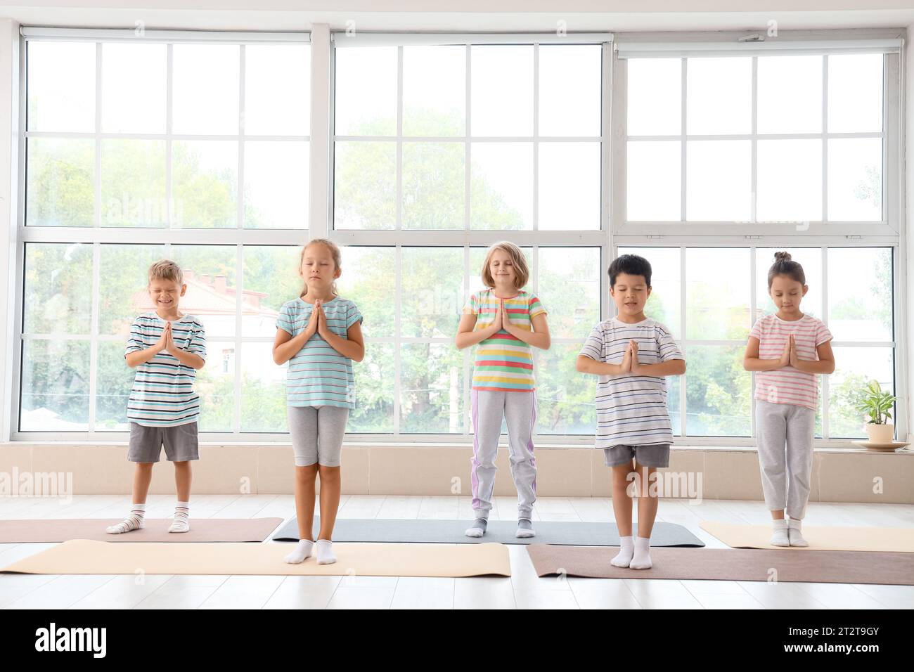 Group of little children practicing yoga in gym Stock Photo - Alamy