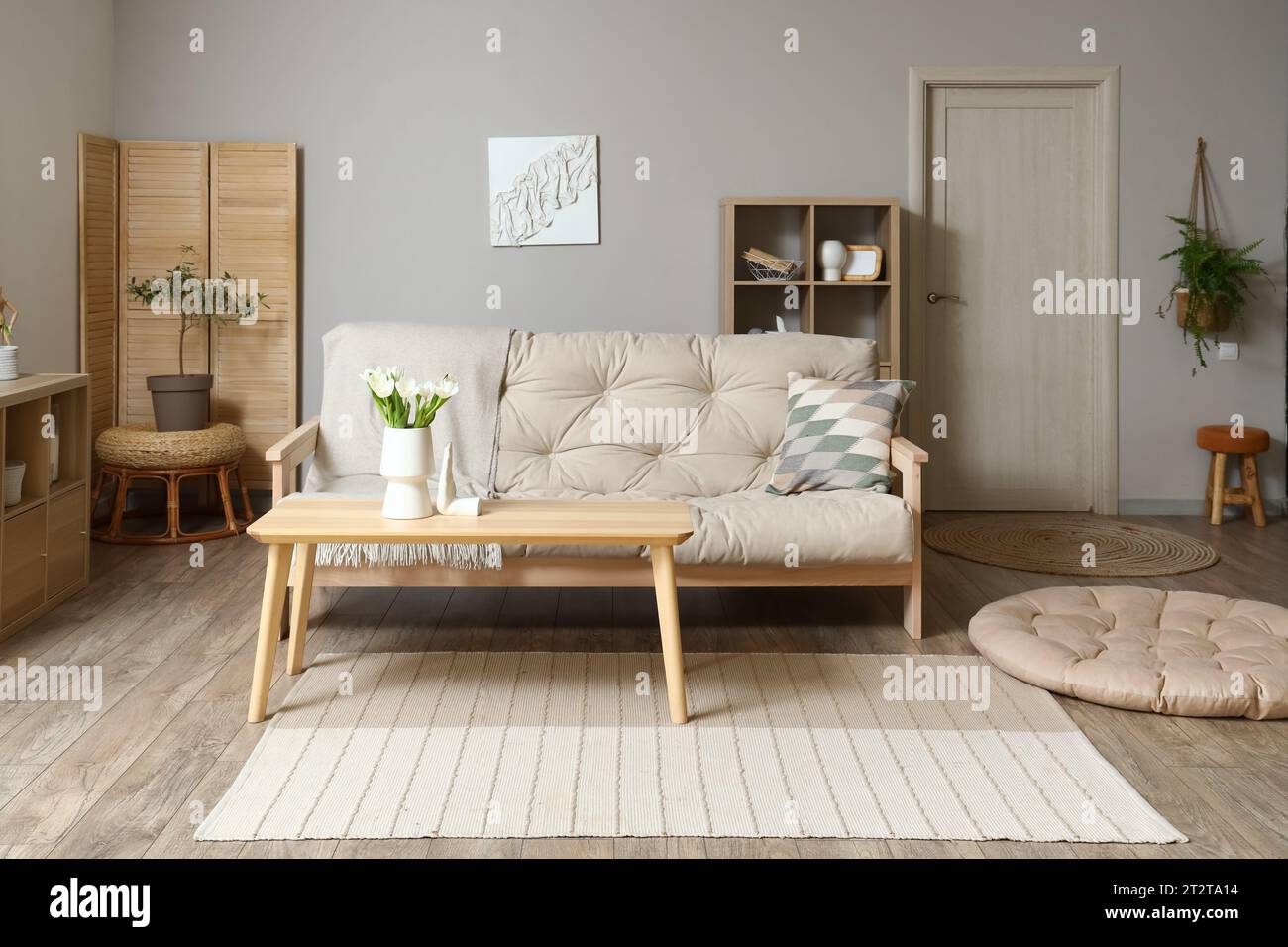Interior of modern living room with couch and table Stock Photo - Alamy