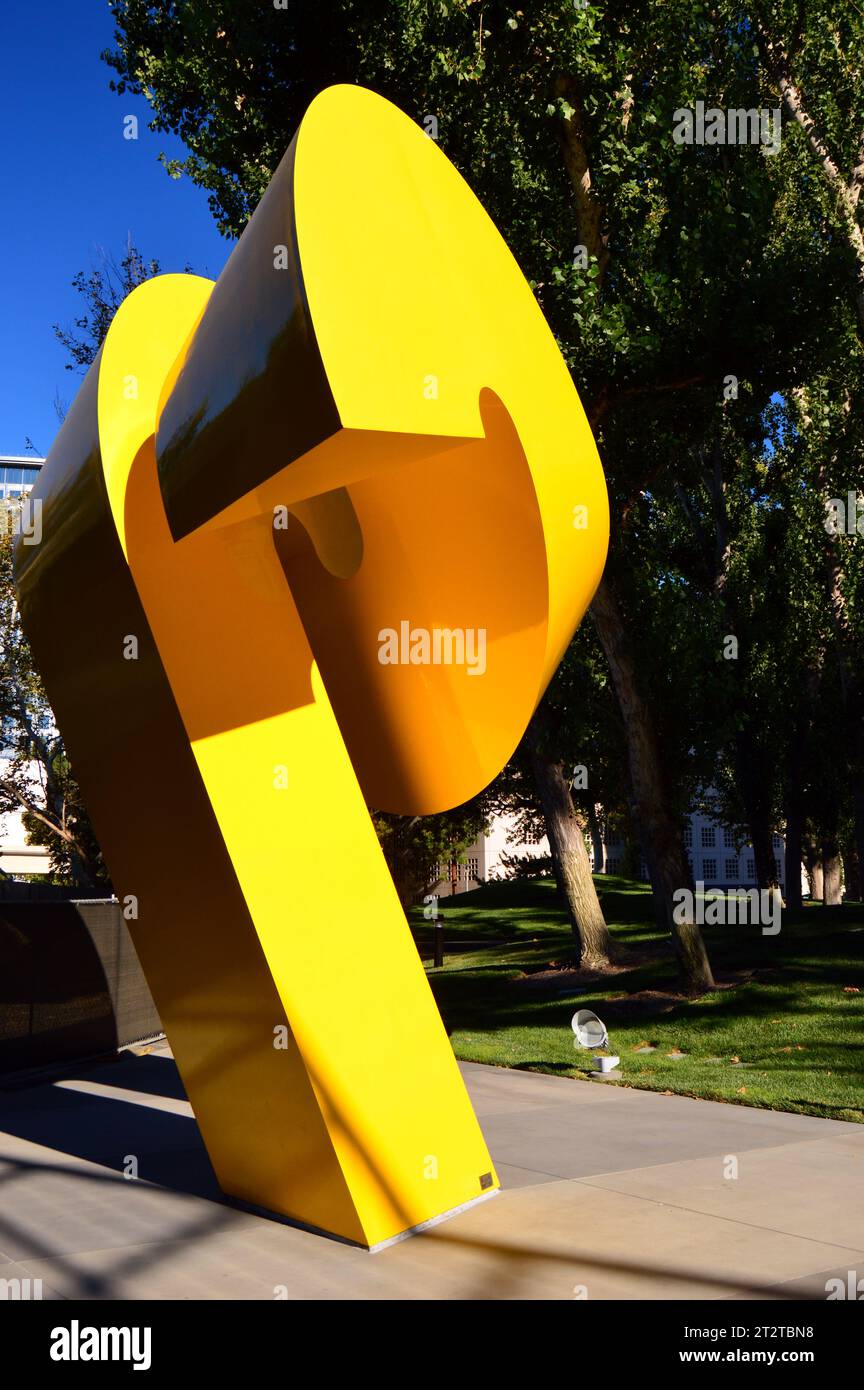 Charles O Perry's yellow sculpture Ram stands-in the courtyard of a business office complex in Costa Mesa California Stock Photo