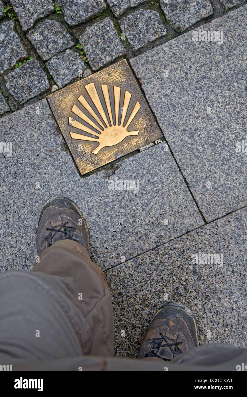 LUGO, October 4, 2023 : A plate on the ground indicates Lugo is on the road to Santiago with the walking shoes of a pilgrim Stock Photo