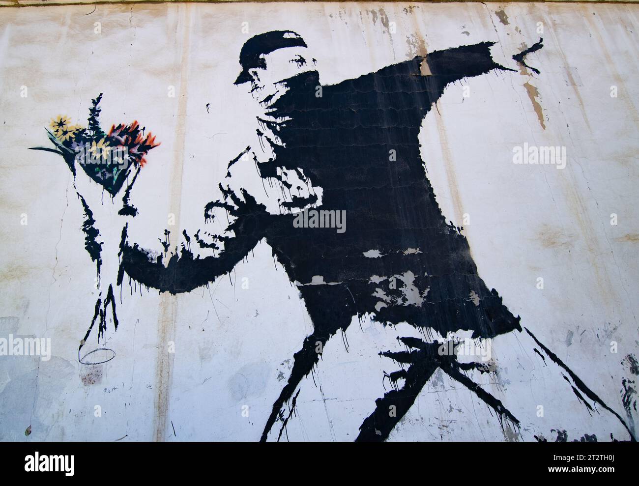 Banksy's famous mural  'Rage, The Flower Thrower (Love Is In The Air)' which is painted on a car wash in a suburb of Betlehem (Palestine Stock Photo