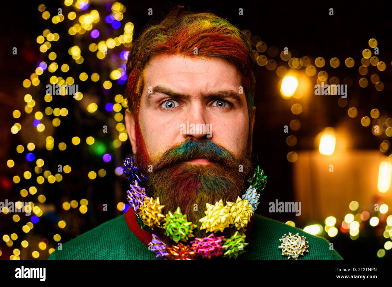 Merry Christmas and Happy new year. Christmas beard decoration. Serious bearded man with decorated beard. Bearded man with dyed hair and decorated Stock Photo