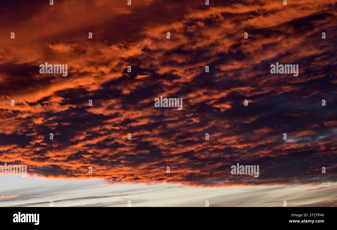 dramatic Red clouds for pattern background. A burning sky in a horror movie. crimson storm in apocalyptic, judgment day. Stock Photo
