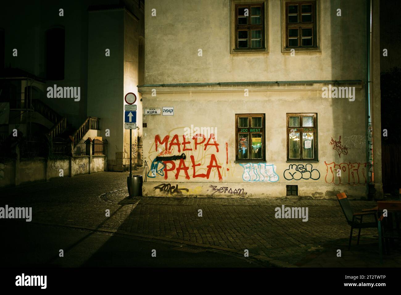Night street scene with graffiti in Kazimierz, Kraków, Poland Stock Photo