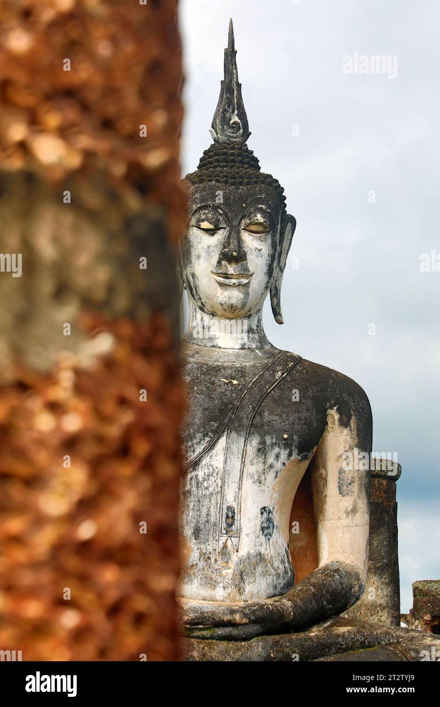 Buddha Statue between pillars, Wat Mahathat Temple, Royal Sanctuary, Sukhothai, Thailand Stock Photo