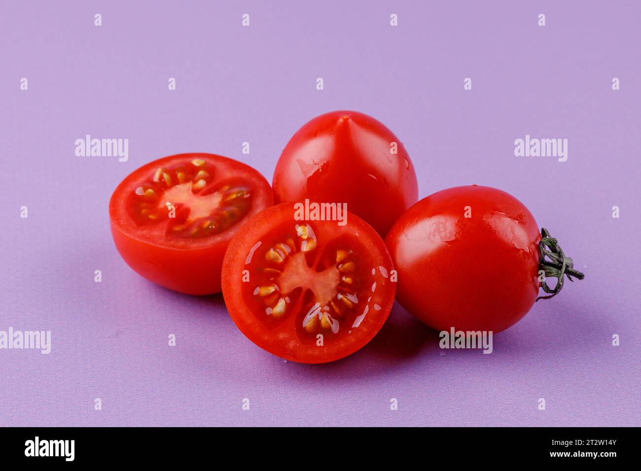 Cherry tomatoes on a pink background Stock Photo