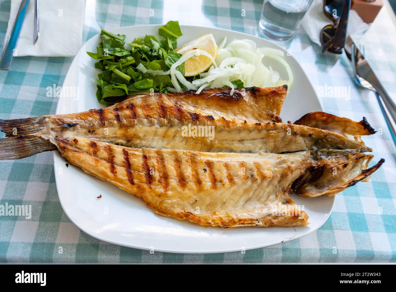 Grilled mackerel on a table. Stock Photo