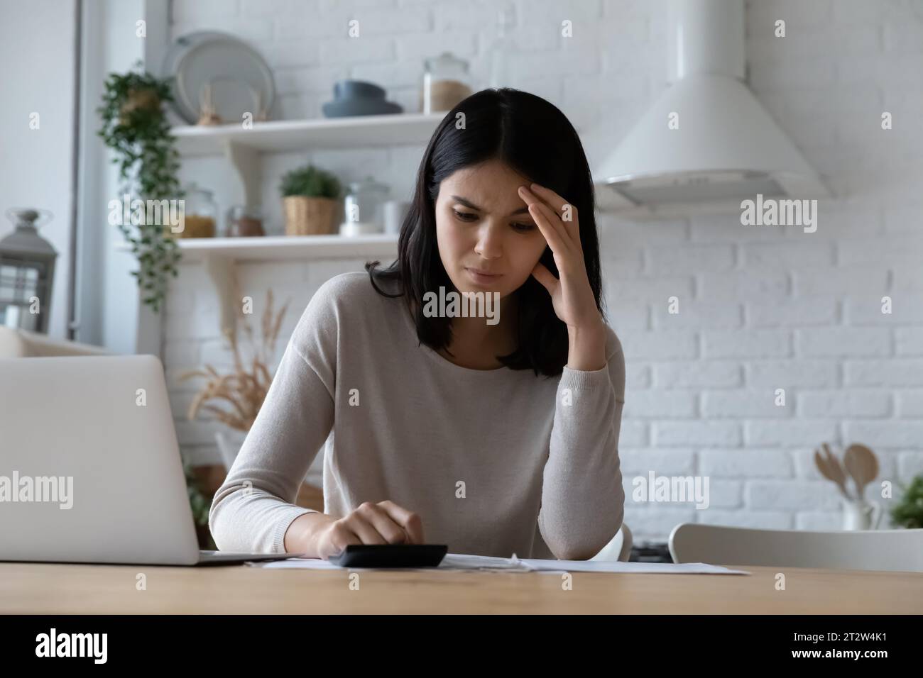 Unhappy stressed Asian woman checking bills, having money problem Stock Photo