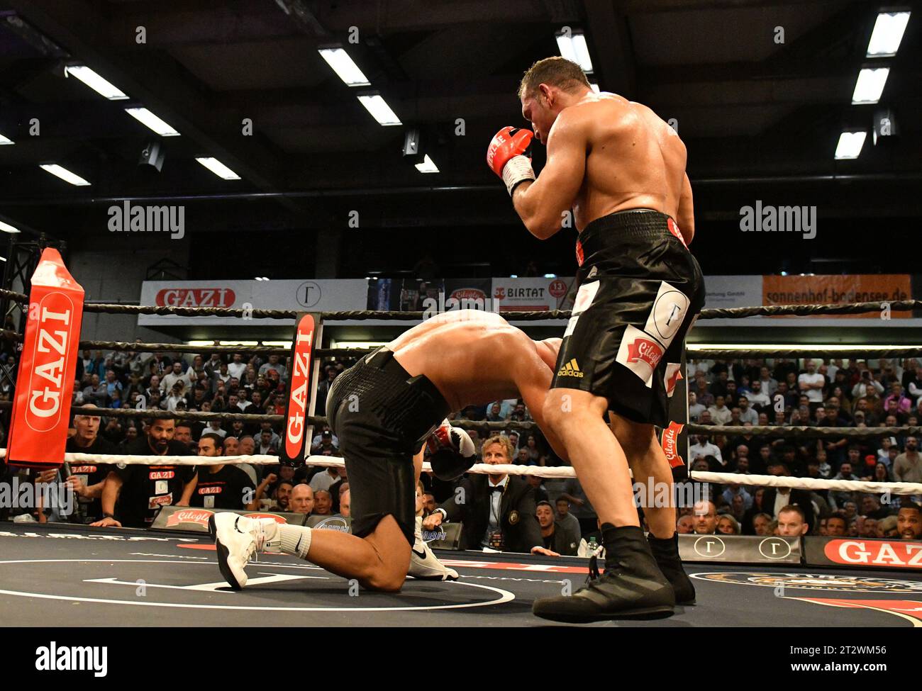 21 October 2023, Baden-Württemberg, Göppingen: Firat Arslan (r) with the knockout punch against Edin Puhalo in the EWS Arena. The 53-year-old Arslan fights against European champion Puhalo (Bosnia) for the WBA Gold World Championship in cruiserweight. It was the last fight of the 53-year-old after 35 years of boxing. Arslan wanted to become the oldest world champion in boxing history. Photo: Jan-Philipp Strobel/dpa Stock Photo