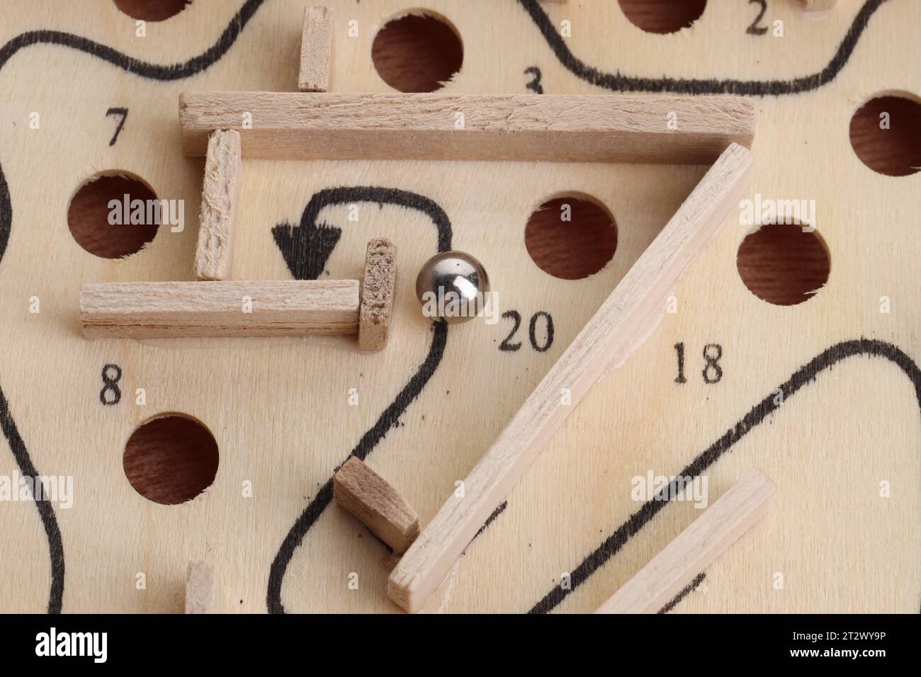 Wooden toy maze with metal ball, above view Stock Photo