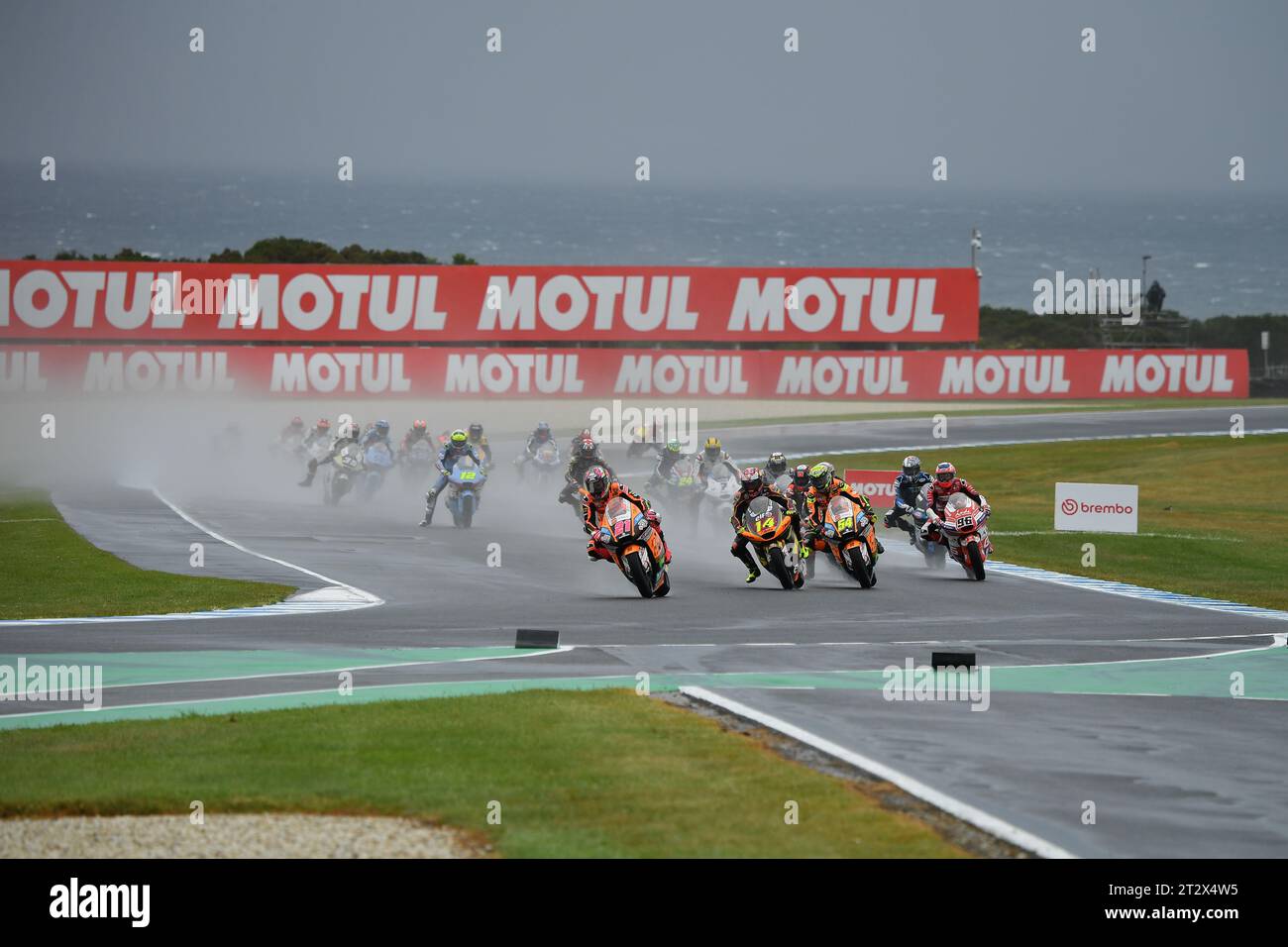 MELBOURNE, AUSTRALIA. 22 October, 2023. Guru by Gryfyn Australian Motorcycle Grand Prix of Australia. Alonso Lopez of Spain, CAG SpeedUp team leads the pack amongst the spray into turn 4 of the Phillip island Circuit during the opening lap of the Moto 2 race at the Australian MotoGP. Photo credit: Karl Phillipson/Alamy Live News Stock Photo