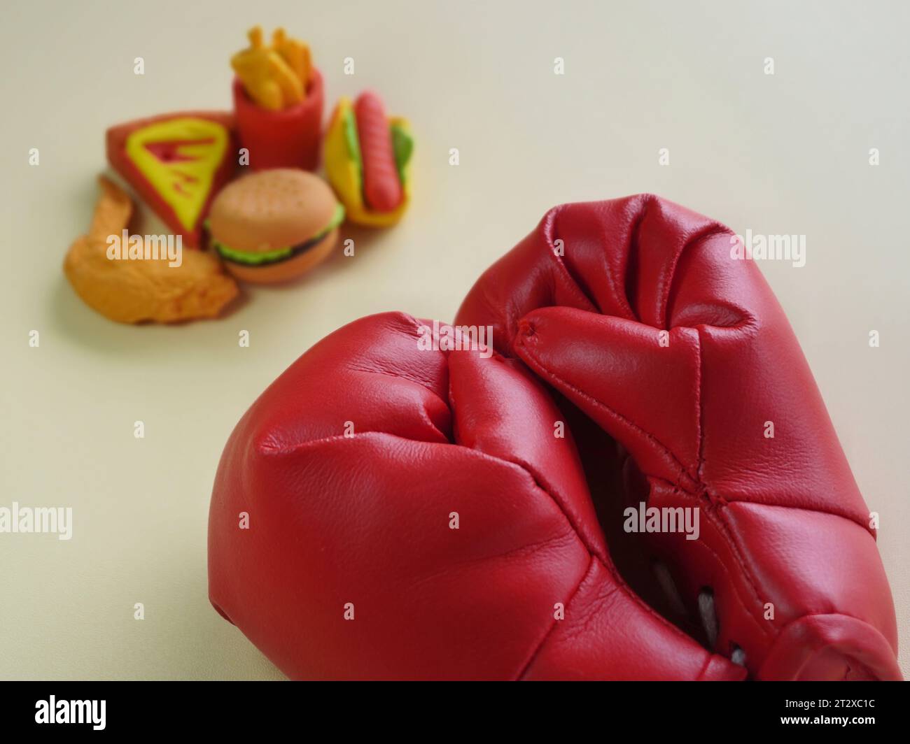 Closeup image of boxing glove and junk foods like burger and fries