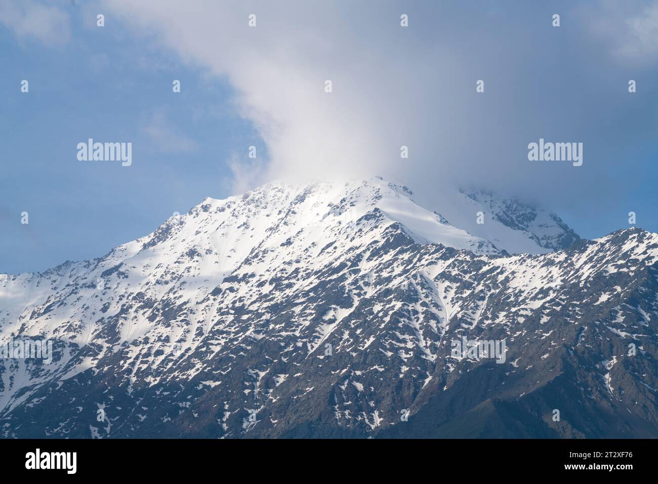 A cloud covers one of the mountain peaks. Caucasus, North Ossetia. Russia Stock Photo