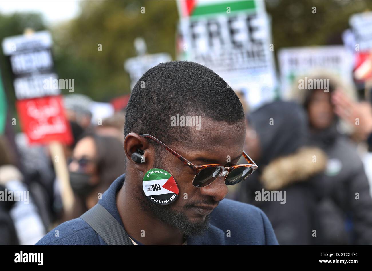 A protester wears a Palestine sticker omn his face as other protesters gather behind him at Marble Arch. Supporters of Palestine come together to march to Downing Street following Israeli bombing and the threat of a ground invasion into Gaza by Israeli forces. This is the second consecutive week that over 100,000 people have taken to the streets of London to protest. There is a general call from many of the organisations involved for a ceasefire, the opening of the Rafah crossing into Egypt and humanitarian aid to be allowed into the Gaza Strip. (Photo by Martin Pope/SOPA Images/Sipa USA) Stock Photo