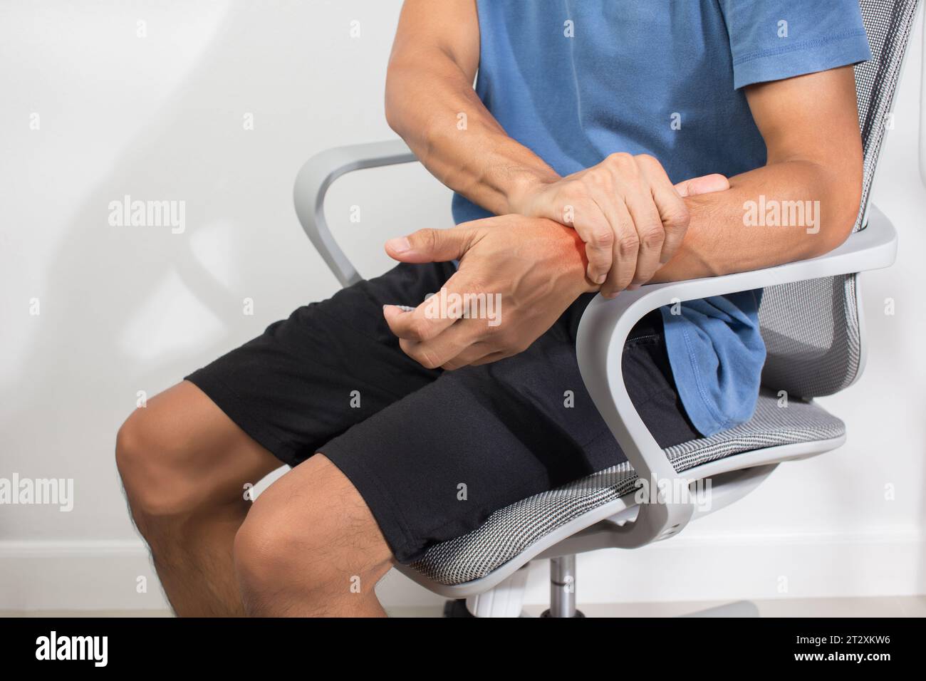 The man has numbness in the wrist. Health care and body care concept. Stock Photo