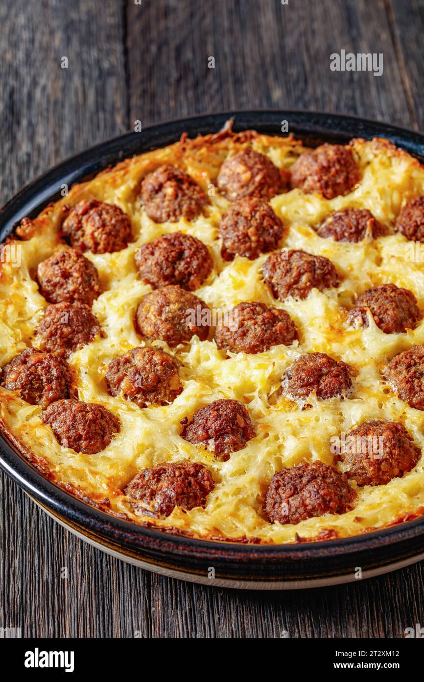 Meatball Hash Brown Casserole in baking dish on dark wooden table