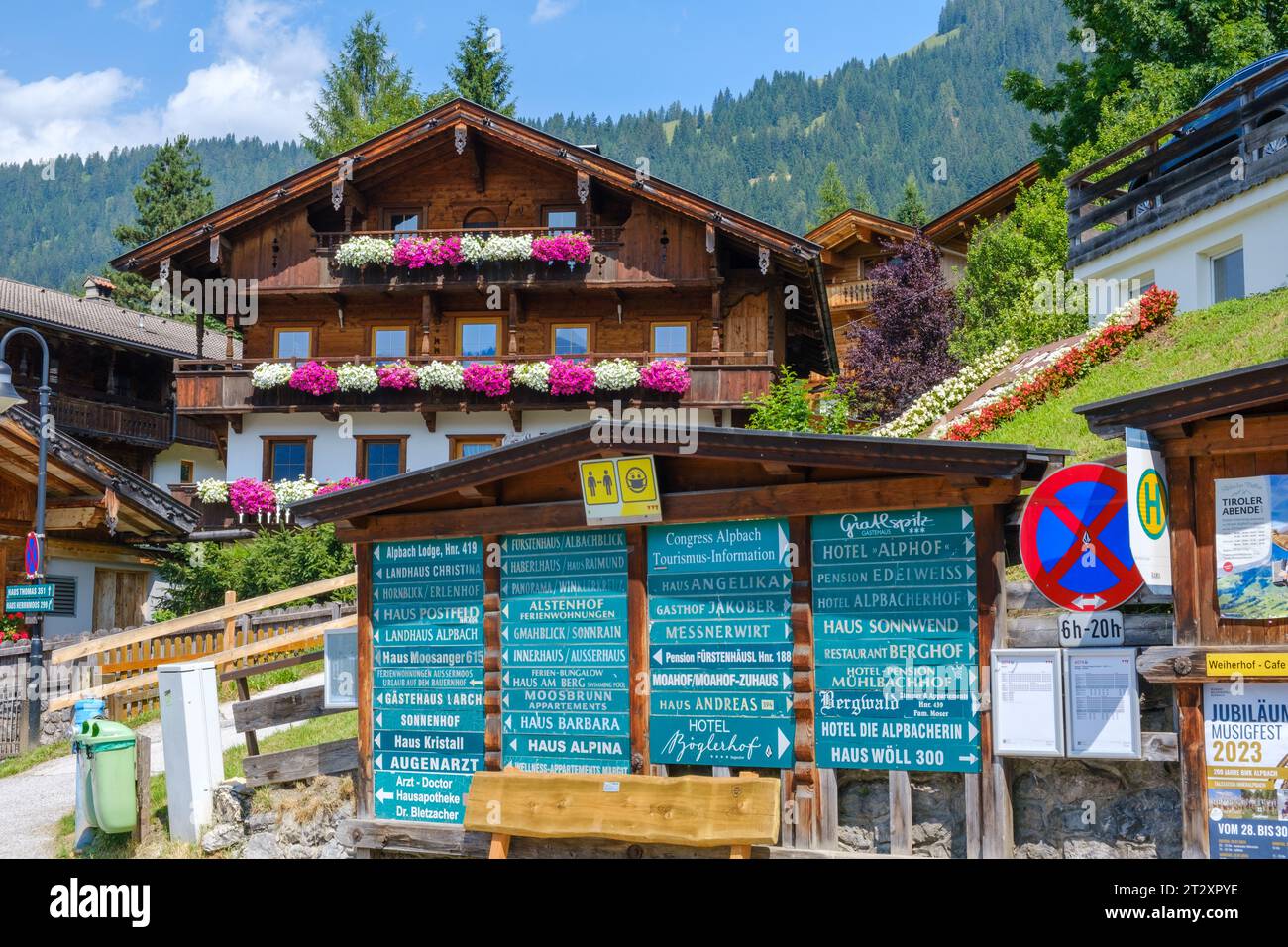 Alpbach Village centre with signs for hotels & guest houses. Traditional Alpine architecture, flowers on balconies. Tyrol, Austria. Stock Photo