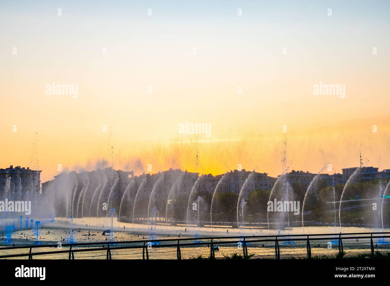 Water fountain with splashes of water for relaxation and coolness of the city and parks. Stock Photo