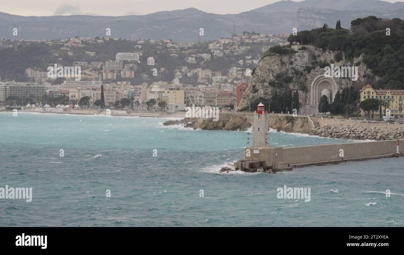 NICE, FRANCE - MARCH 8, 2023: Nice port entrance with lighthouse with windy weather, editorial travel Stock Photo