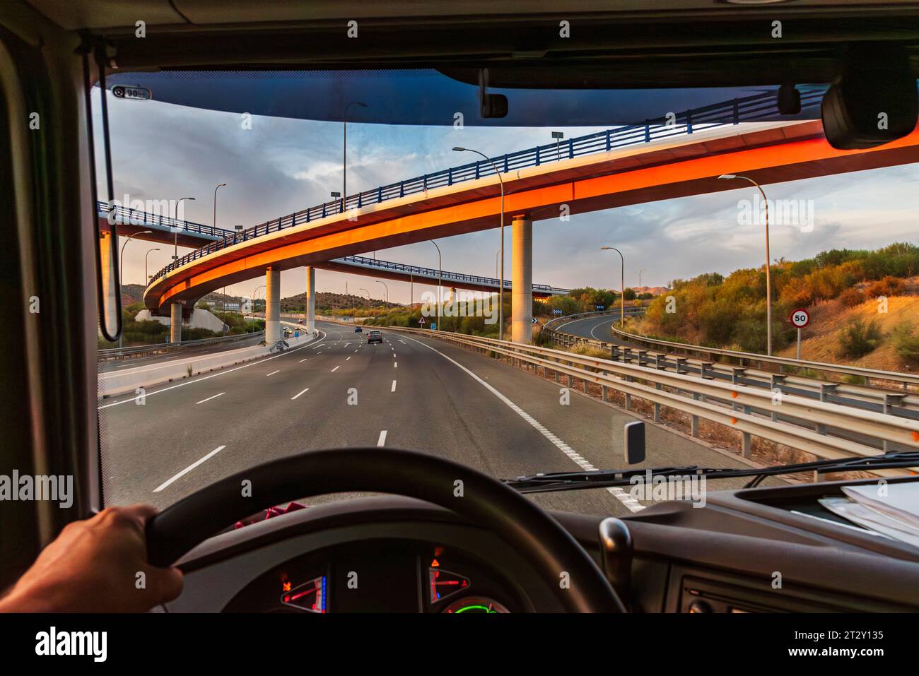 View from the driving position of a truck of a highway with several bridges at different levels. Stock Photo