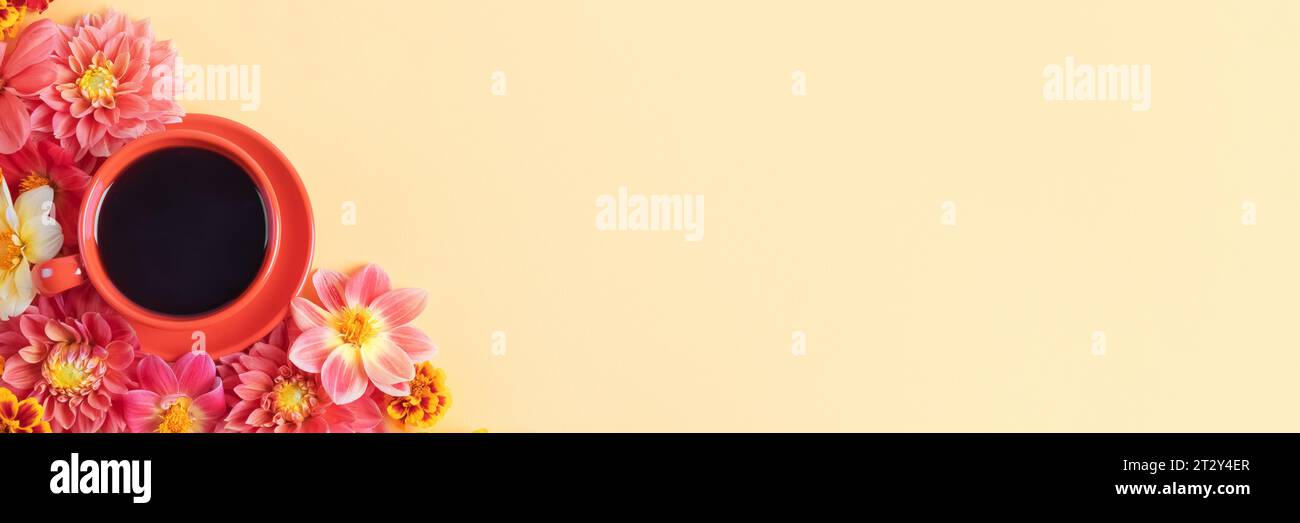 Autumn composition of a red coffee cup and dahlia flowers on a yellow background with a place for text. Flat lay, banner. Nature concept Stock Photo