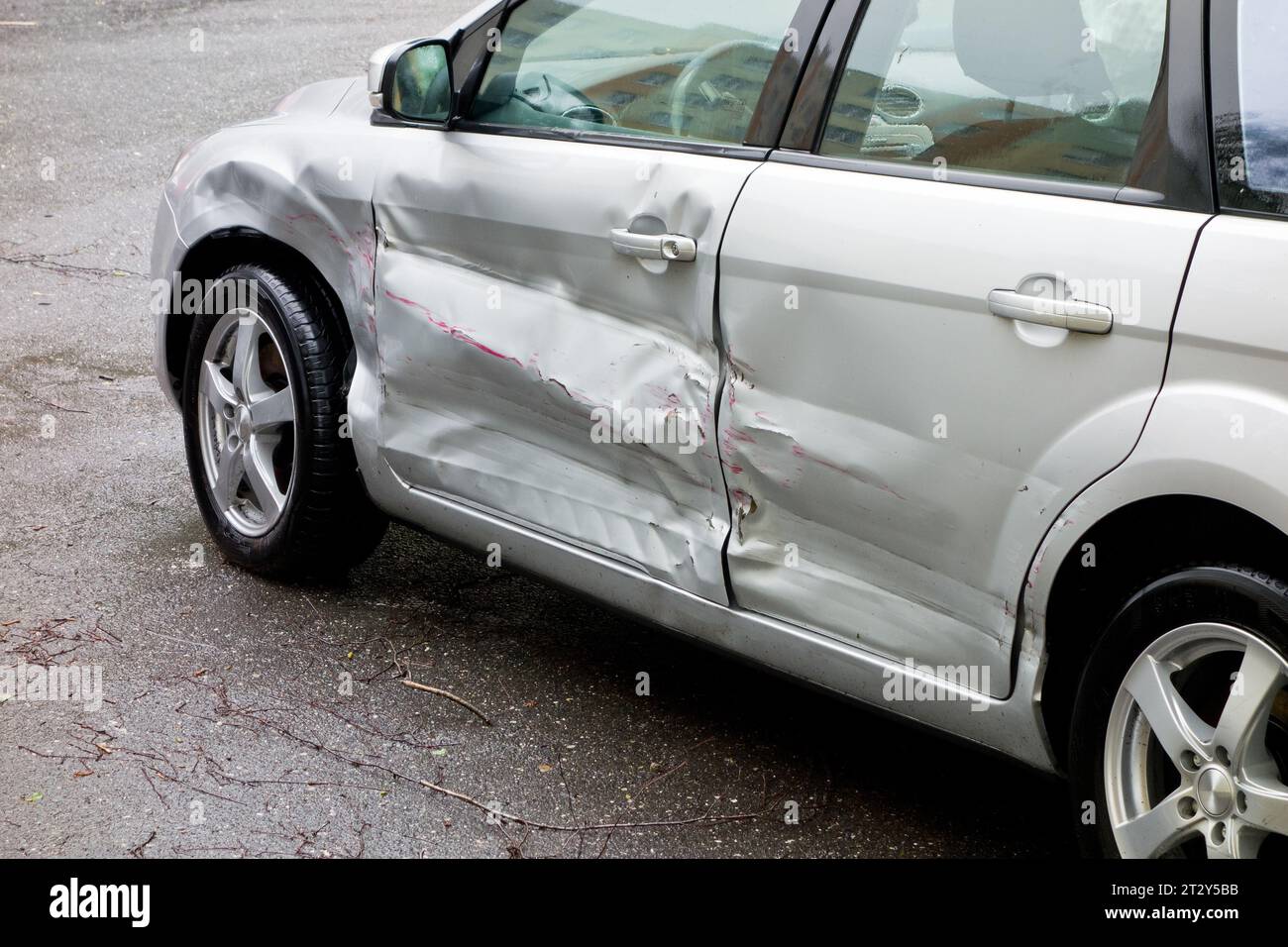 Damaged silver car, scratches on the doors Stock Photo