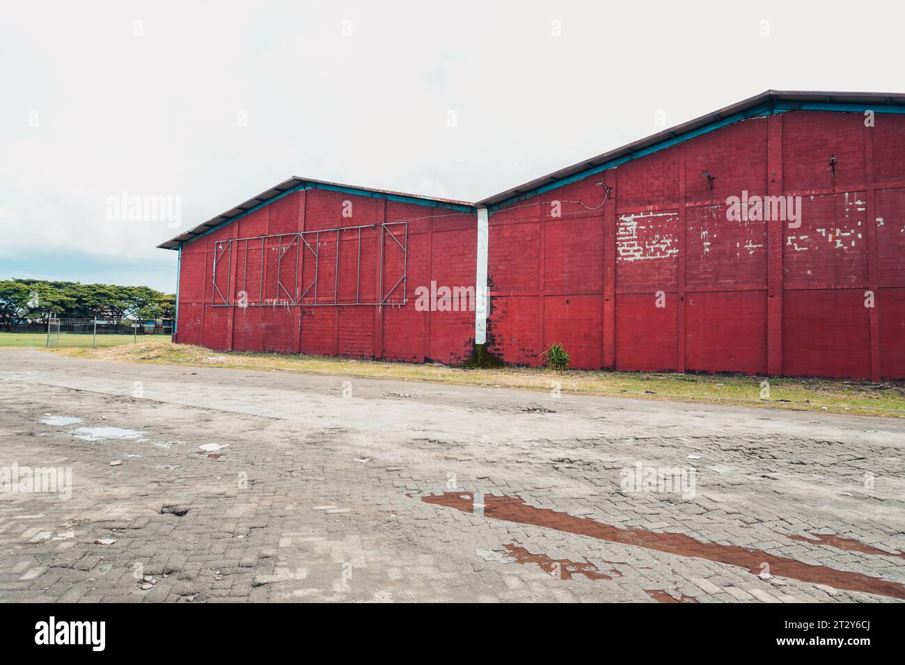 Vibrant warehouse backdrop with red wall and banner frame Stock Photo