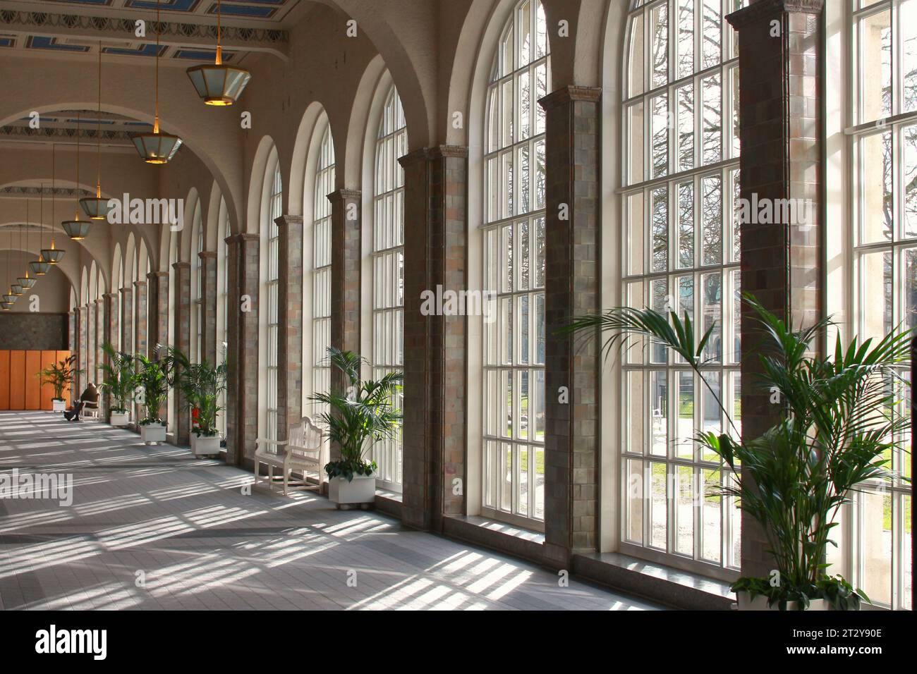 A long an high Hall with large Windows in Bad Kissingen Germany. The Sun is shining through the Windows an projecting nice lights on the Floor Stock Photo