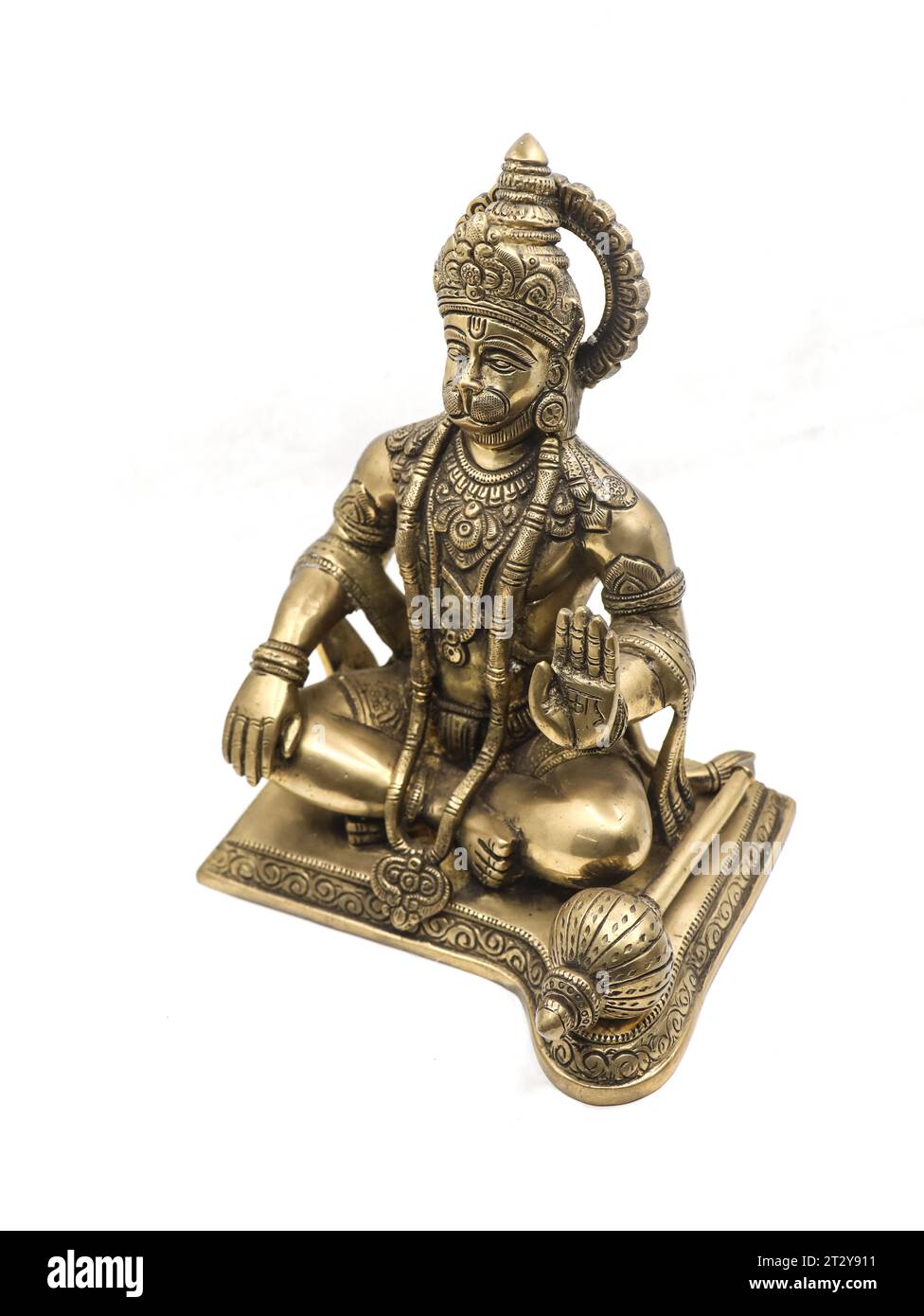 statue of lord hanuman, a monkey god from hindu mythology sitting and blessing made of golden brass isolated in a white background Stock Photo