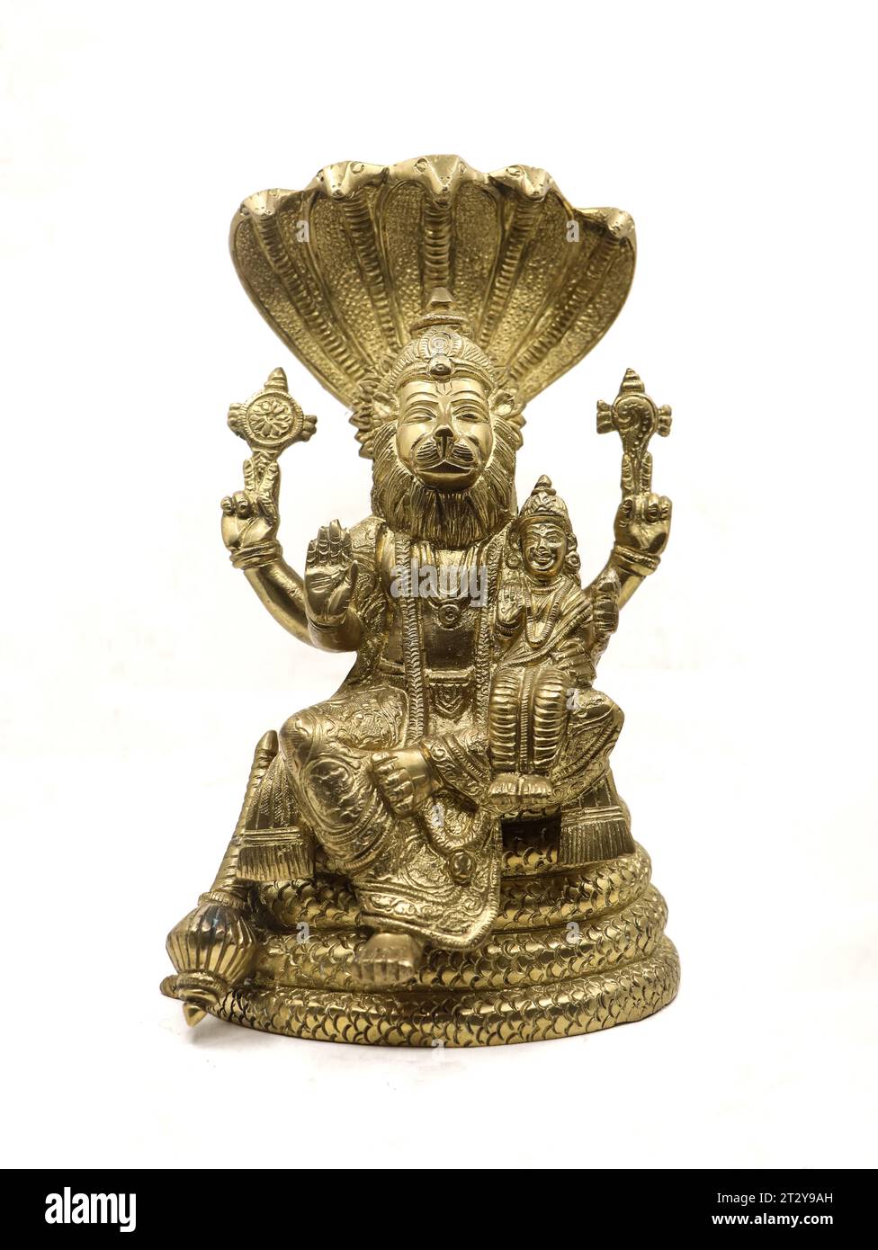 golden statue of lord vishnu avatar, narasimha lion faced with multiple hands sitting on a snake with multiple heads next to goddess lakshmi Stock Photo