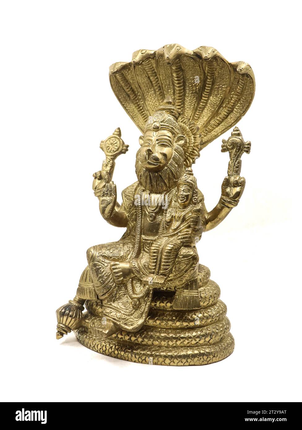 golden statue of lord vishnu avatar, narasimha lion faced with multiple hands sitting on a snake with multiple heads next to goddess lakshmi, isolated Stock Photo