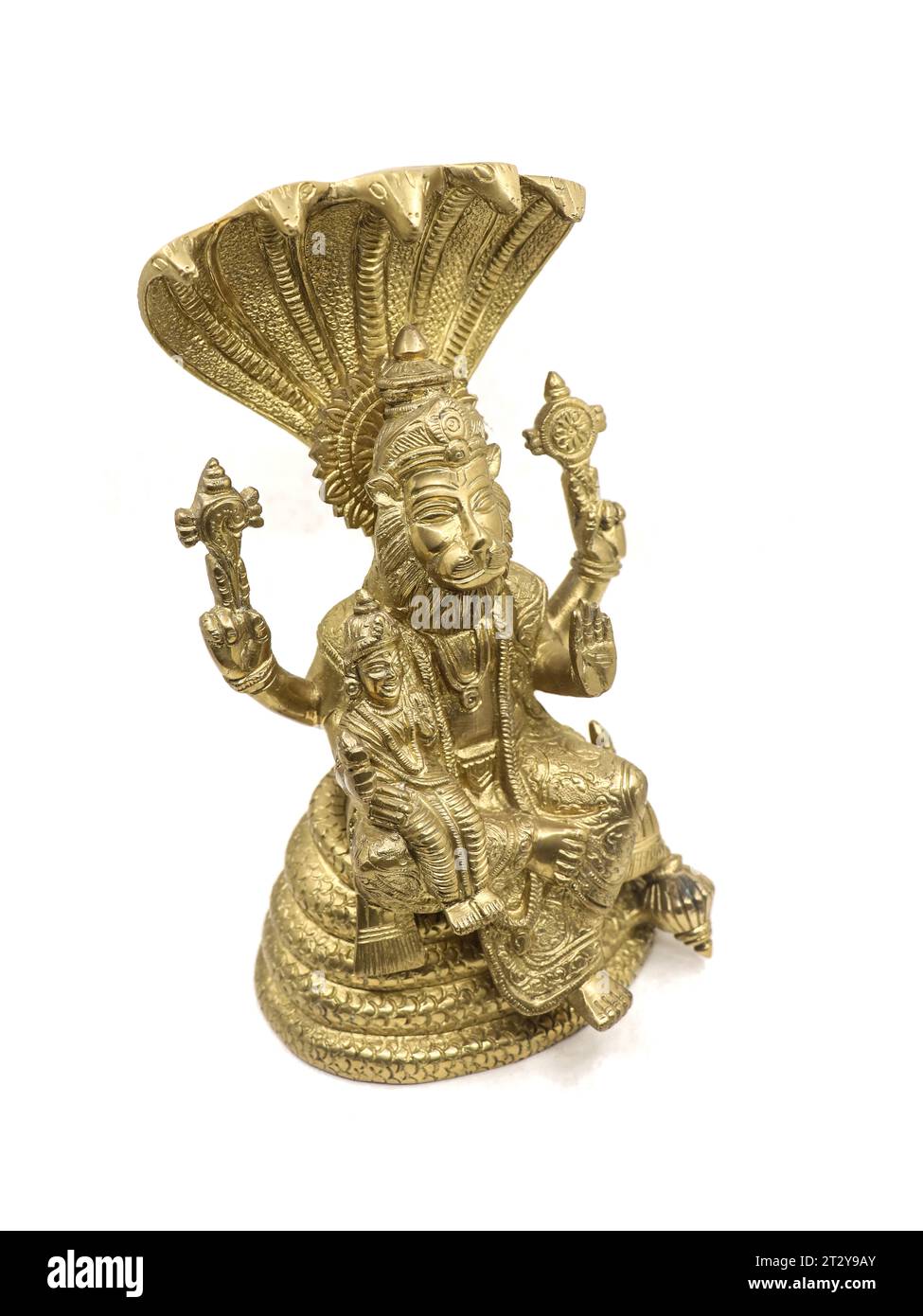 golden statue of lord vishnu avatar, narasimha lion faced with multiple hands sitting on a snake with multiple heads next to goddess lakshmi, isolated Stock Photo