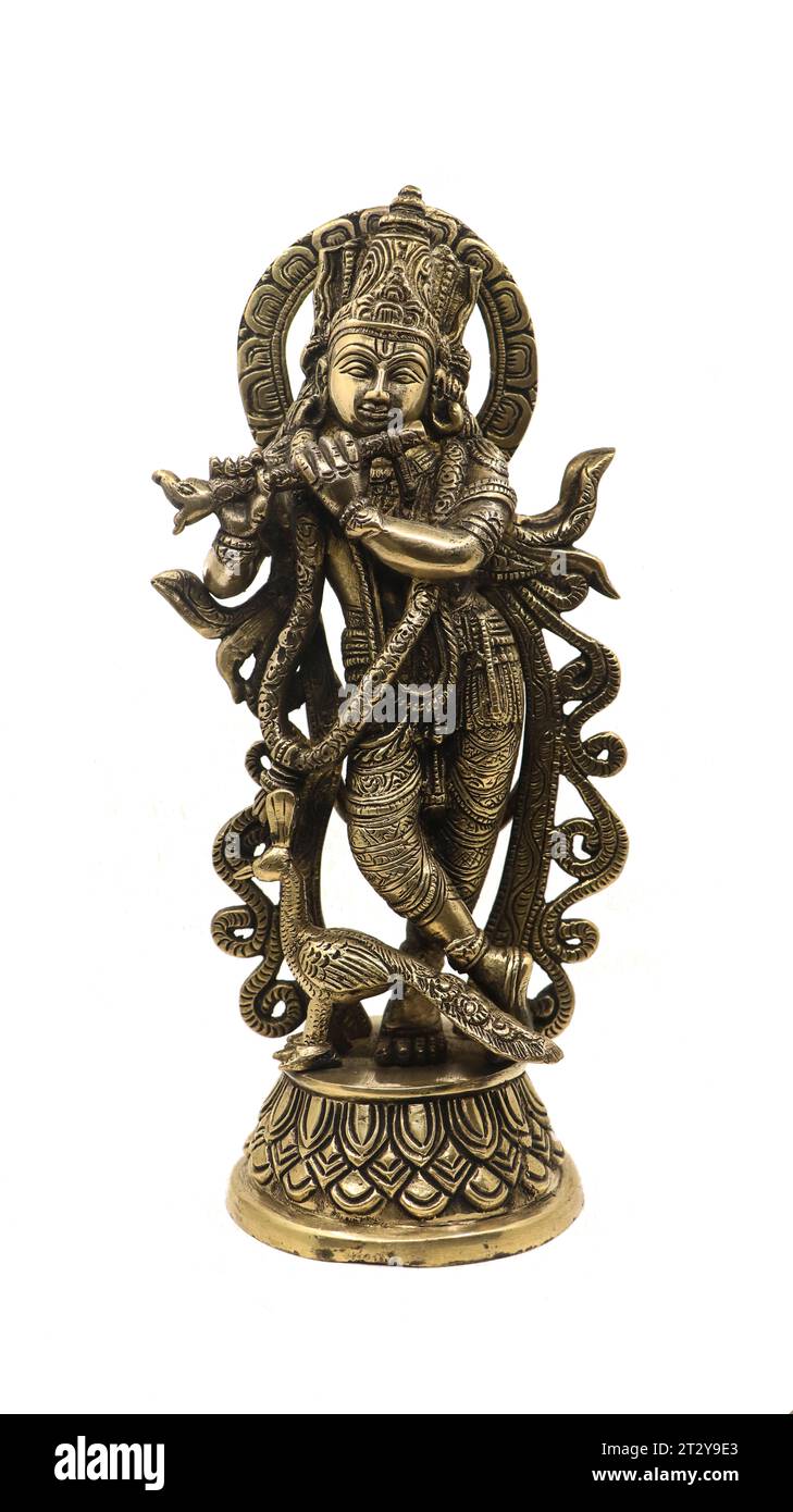 lord vishnu avatar, krishna playing flute music next to a peacock, antique indian bronze sculpture with detailed carvings isolated Stock Photo