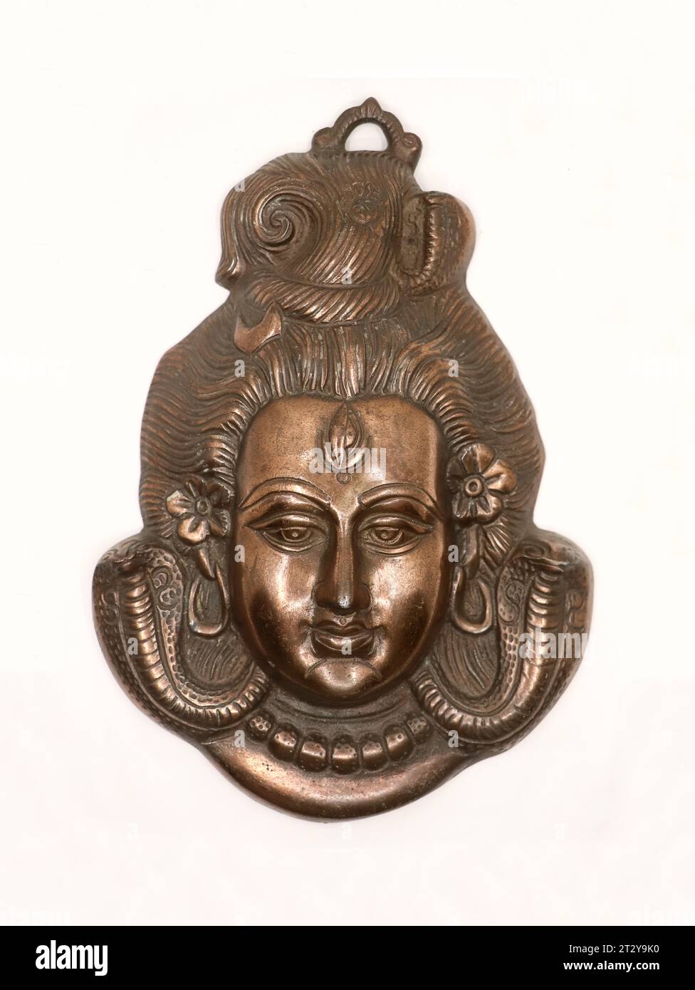face statue of god shiv of hindu religion made of copper isolated Stock Photo