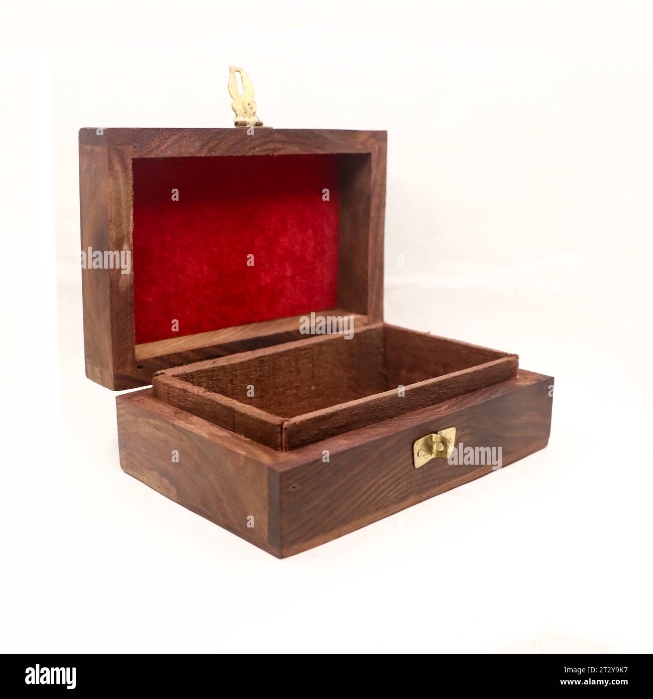 a brown, handcrafted wooden gift box for storing jewellery and money with red velvet lining, empty and open isolated Stock Photo