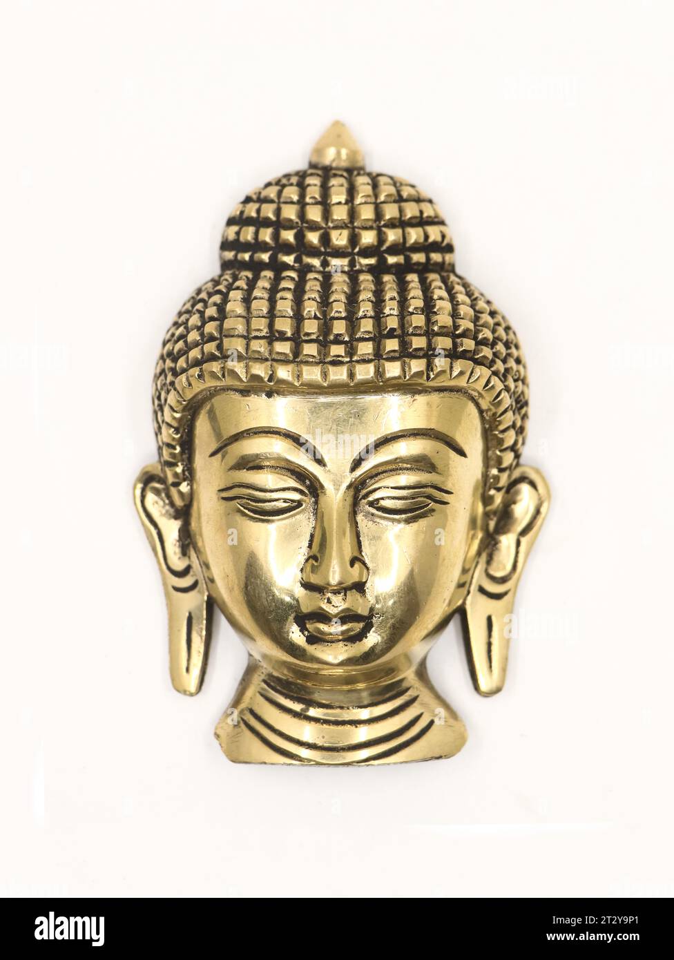 an isolated buddha gold figure head statue, an antique religious symbol of luck in a white background Stock Photo