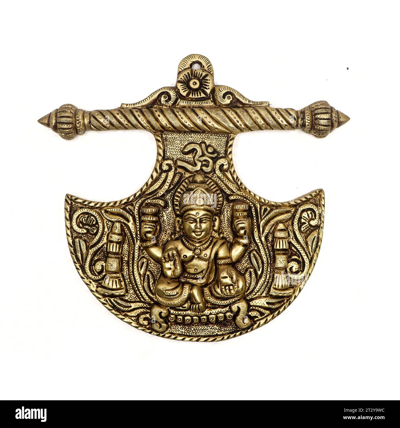 isolated hindu goddess lakshmi medallion idol with detailed engravings carved on the golden brass pendant in closeup Stock Photo