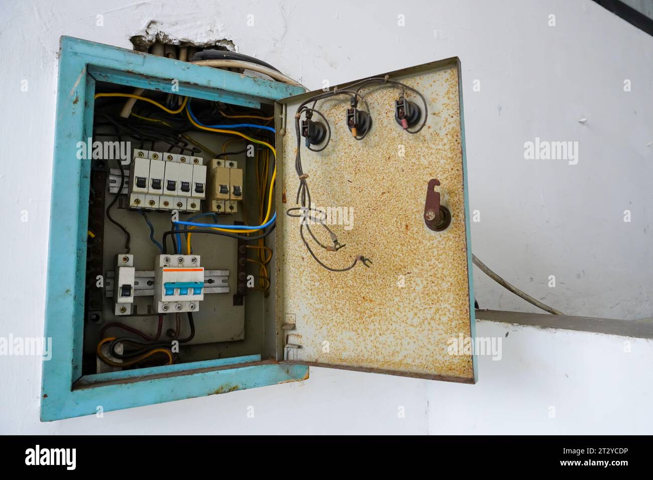 Power distribution board. Electrical panel with a row of fuses for different areas in a building, set against a white wall Stock Photo