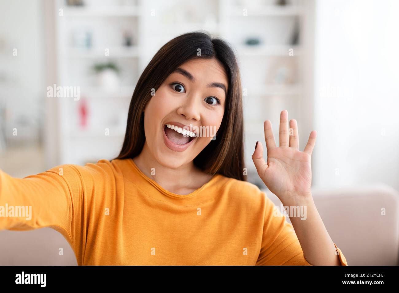 Positive young asian woman taking selfie at home Stock Photo - Alamy