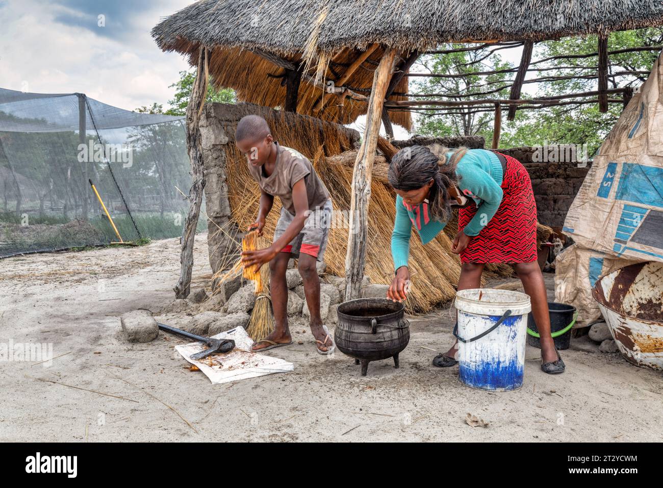 african village family cooking food in the outdoors kitchen Stock Photo