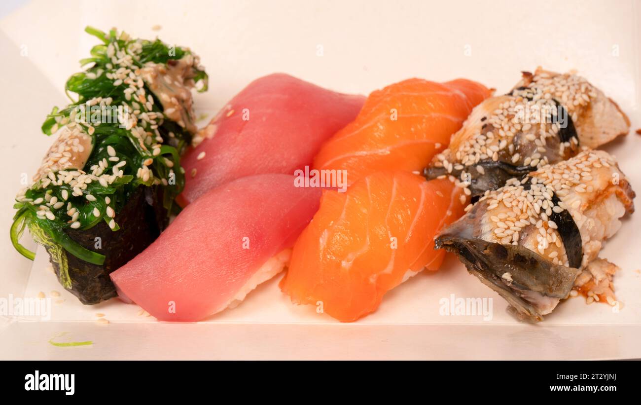 Sushi with salmon, eel, tuna, hiyashi wakame, sesame isolated on a ...